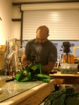 Dan repairs a rod puppet for a frog character.